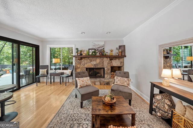 545 Matterhorn Way, Alpharetta, GA 30022 - living area featuring wood finished floors, a textured ceiling, a fireplace, ornamental molding, and baseboards