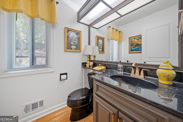 545 Matterhorn Way, Alpharetta, GA 30022 - bathroom featuring wood finished floors, toilet, healthy amount of natural light, and vanity