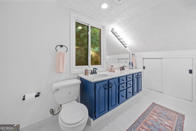 545 Matterhorn Way, Alpharetta, GA 30022 - bathroom with a textured ceiling, double vanity, toilet, and vaulted ceiling