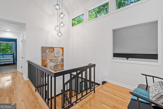 545 Matterhorn Way, Alpharetta, GA 30022 - staircase featuring attic access, plenty of natural light, wood finished floors, and baseboards