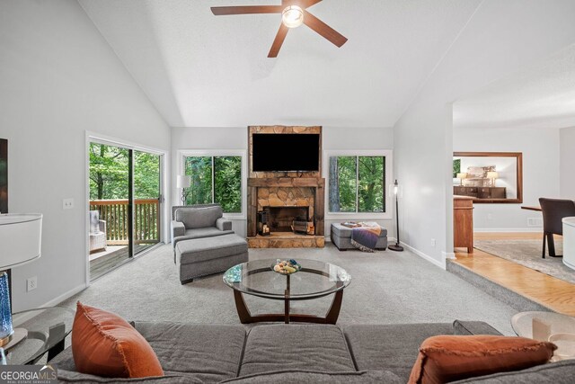 545 Matterhorn Way, Alpharetta, GA 30022 - carpeted living room featuring plenty of natural light, ceiling fan, a stone fireplace, lofted ceiling, and baseboards