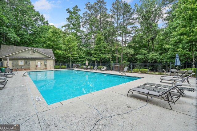 545 Matterhorn Way, Alpharetta, GA 30022 - community pool featuring a patio and view of wooded area