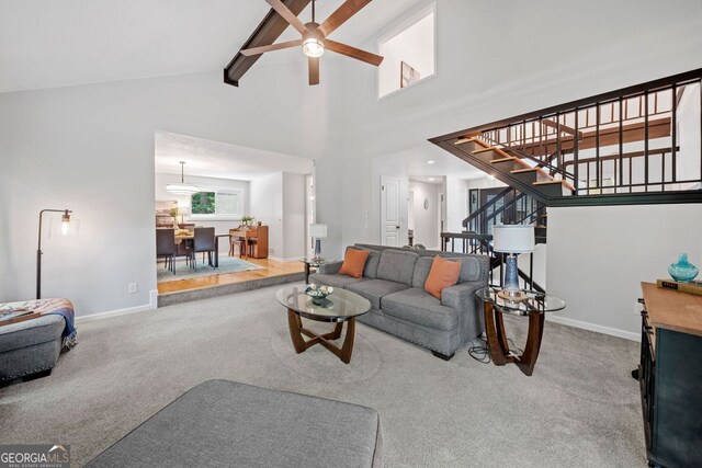 545 Matterhorn Way, Alpharetta, GA 30022 - living area featuring ceiling fan, beamed ceiling, stairs, carpet flooring, and high vaulted ceiling