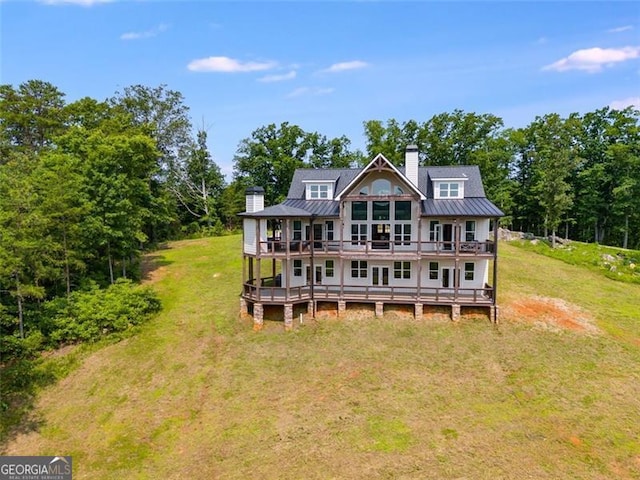 1204 Springdale Rd, Rockmart, GA 30153 - rear view of property with a chimney, a wooden deck, a lawn, a standing seam roof, and a metal roof