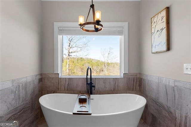 1204 Springdale Rd, Rockmart, GA 30153 - full bath featuring a chandelier, a freestanding bath, and tile walls