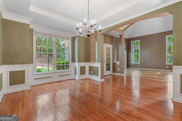 168 Eagle Pointe Dr, Dahlonega, GA 30533 - unfurnished dining area with wood-type flooring, arched walkways, a chandelier, and a tray ceiling
