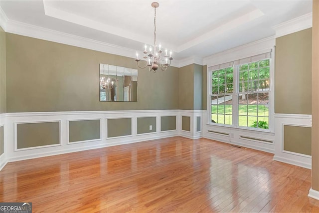 168 Eagle Pointe Dr, Dahlonega, GA 30533 - empty room featuring a raised ceiling, a chandelier, hardwood / wood-style floors, ornamental molding, and a wainscoted wall