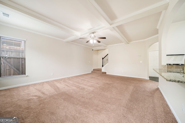 212 Jetta Cir, Mcdonough, GA 30253 - unfurnished living room featuring carpet floors, stairway, arched walkways, beam ceiling, and ceiling fan