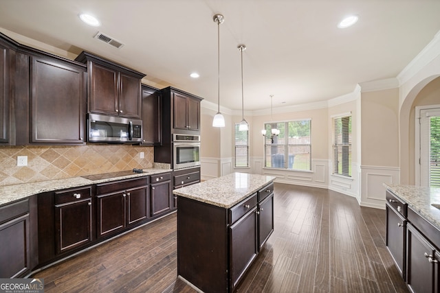 212 Jetta Cir, Mcdonough, GA 30253 - kitchen with appliances with stainless steel finishes, arched walkways, dark brown cabinets, a decorative wall, and ornamental molding