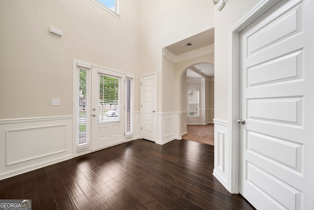 212 Jetta Cir, Mcdonough, GA 30253 - foyer featuring arched walkways, a wainscoted wall, ornamental molding, dark wood-style flooring, and a decorative wall