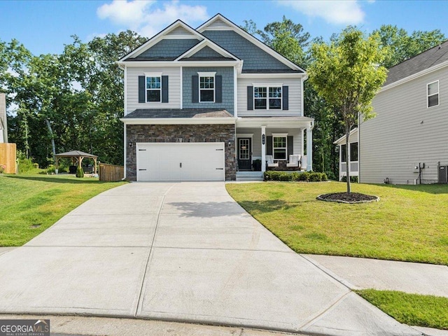340 Louise Ln, Canton, GA 30114 - craftsman-style house with covered porch, concrete driveway, a garage, and a front lawn