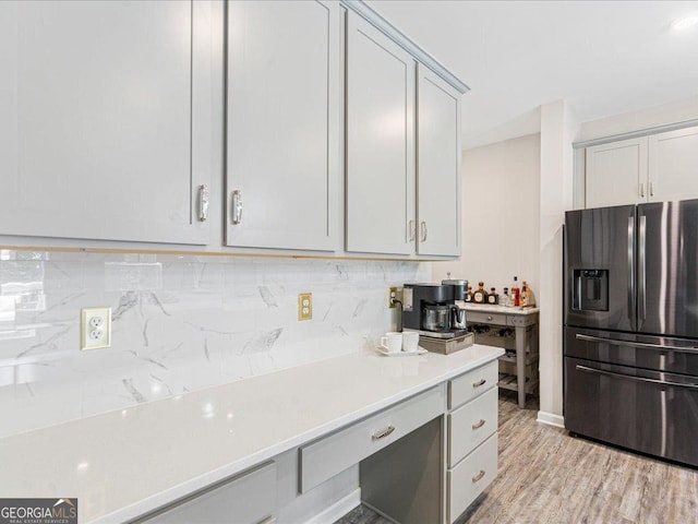 340 Louise Ln, Canton, GA 30114 - kitchen with stainless steel fridge, light countertops, backsplash, light wood-style flooring, and gray cabinets