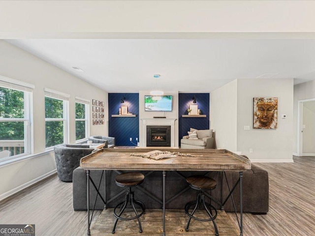 340 Louise Ln, Canton, GA 30114 - living area featuring baseboards, a warm lit fireplace, wood finished floors, and an accent wall