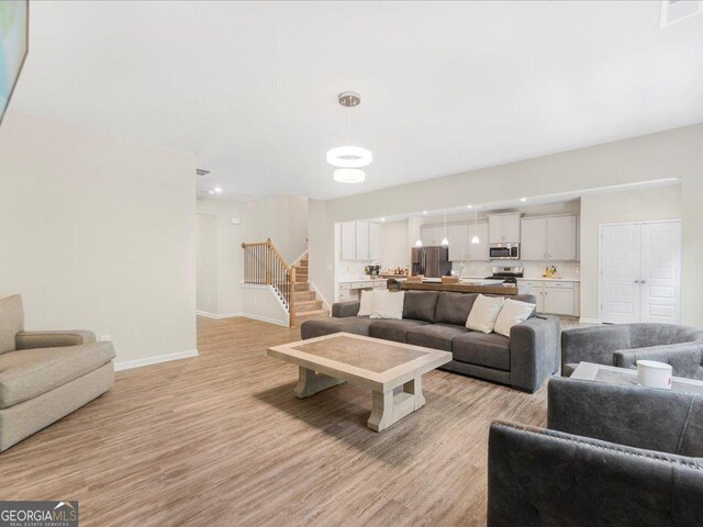 340 Louise Ln, Canton, GA 30114 - living area with baseboards, stairway, and light wood-style flooring