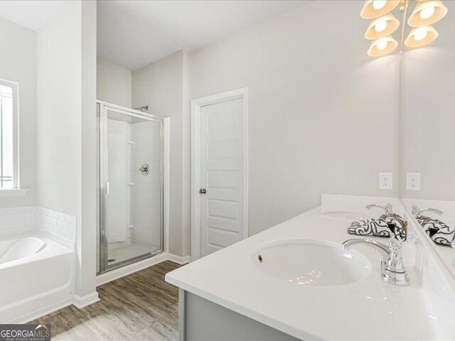 340 Louise Ln, Canton, GA 30114 - full bathroom with a stall shower, a garden tub, wood finished floors, double vanity, and a chandelier