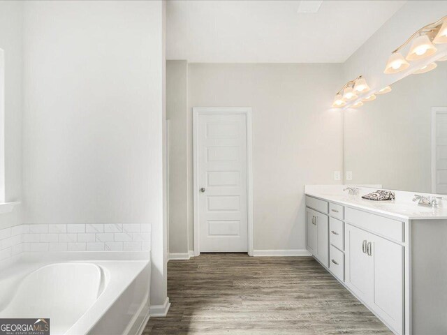 340 Louise Ln, Canton, GA 30114 - full bathroom featuring double vanity, a garden tub, wood finished floors, and baseboards