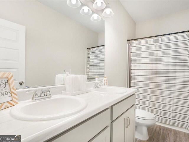 340 Louise Ln, Canton, GA 30114 - bathroom featuring double vanity, toilet, wood finished floors, and curtained shower