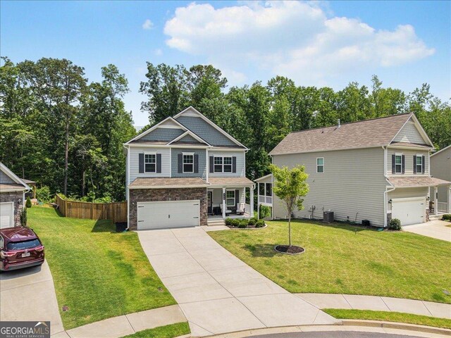 340 Louise Ln, Canton, GA 30114 - craftsman-style house with covered porch, an attached garage, driveway, and a front yard