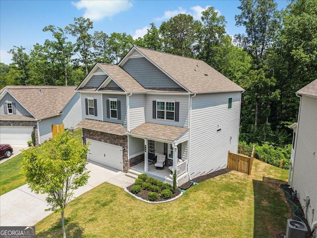 340 Louise Ln, Canton, GA 30114 - craftsman-style house featuring a porch, a garage, concrete driveway, a front lawn, and roof with shingles