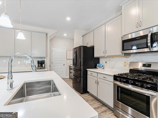 340 Louise Ln, Canton, GA 30114 - kitchen with appliances with stainless steel finishes, a sink, decorative backsplash, light countertops, and recessed lighting