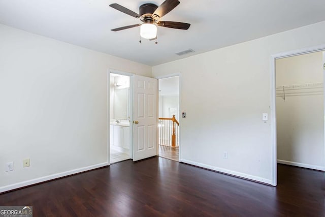 4045 Hillcrest View Ct, Suwanee, GA 30024 - unfurnished bedroom featuring wood finished floors, baseboards, a walk in closet, a closet, and a ceiling fan