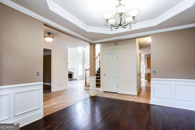 4045 Hillcrest View Ct, Suwanee, GA 30024 - spare room with stairway, wood finished floors, a chandelier, crown molding, and a tray ceiling