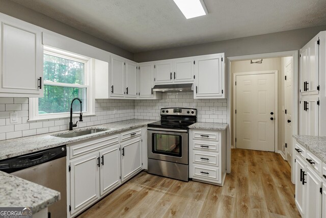 870 Rutherford Dr, Dacula, GA 30019 - kitchen featuring stainless steel appliances, under cabinet range hood, white cabinets, and light wood-type flooring