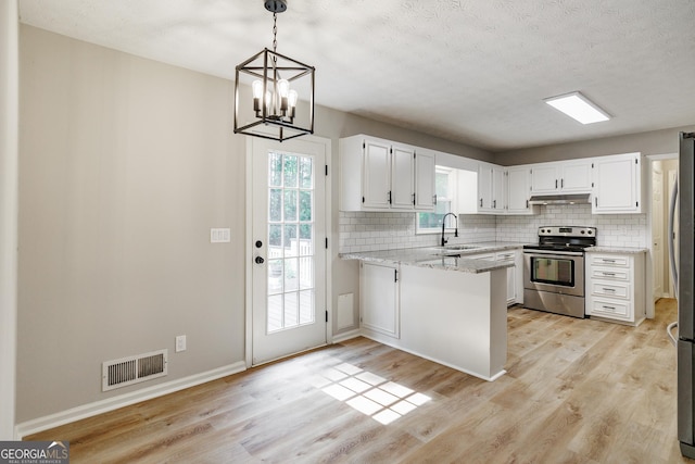 870 Rutherford Dr, Dacula, GA 30019 - kitchen with appliances with stainless steel finishes, under cabinet range hood, backsplash, a peninsula, and light wood-style flooring