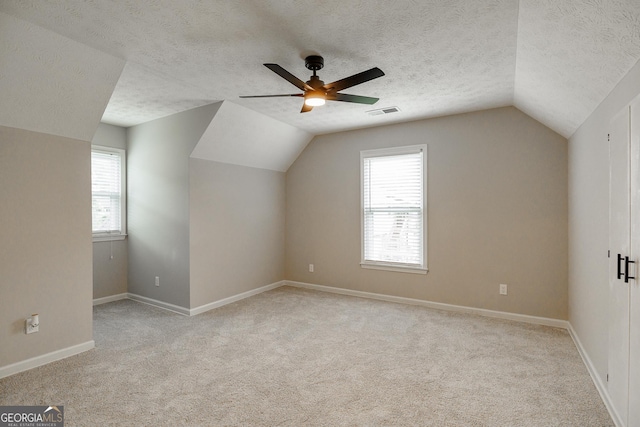 870 Rutherford Dr, Dacula, GA 30019 - additional living space with vaulted ceiling, carpet, a ceiling fan, and a textured ceiling