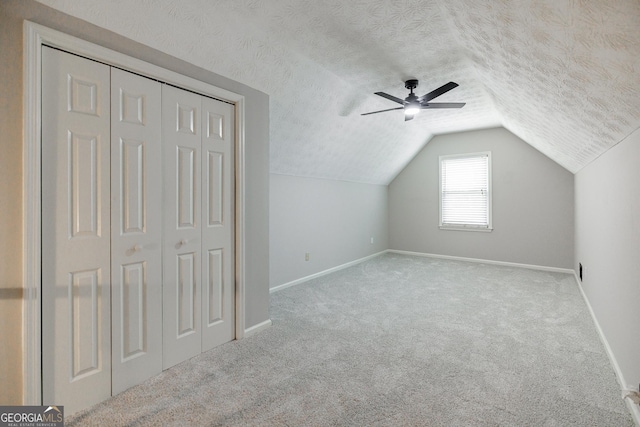 870 Rutherford Dr, Dacula, GA 30019 - bonus room featuring vaulted ceiling, carpet, a textured ceiling, and a ceiling fan