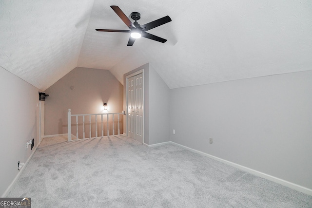 870 Rutherford Dr, Dacula, GA 30019 - bonus room with lofted ceiling, carpet, a ceiling fan, and a textured ceiling