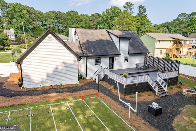 870 Rutherford Dr, Dacula, GA 30019 - back of property featuring a deck, a fenced backyard, a chimney, and roof with shingles