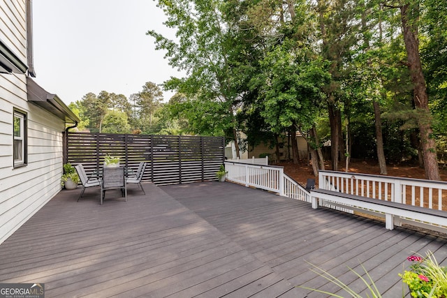870 Rutherford Dr, Dacula, GA 30019 - deck featuring outdoor dining area and view of scattered trees