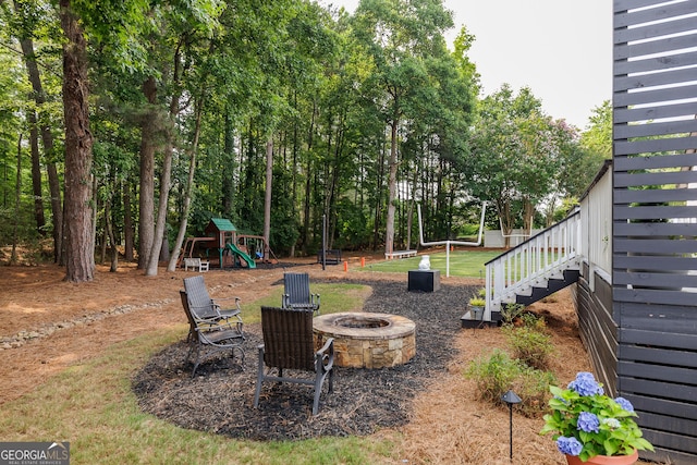 870 Rutherford Dr, Dacula, GA 30019 - view of yard featuring a playground, a fire pit, and stairway