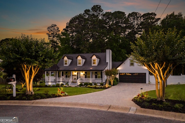 870 Rutherford Dr, Dacula, GA 30019 - new england style home featuring covered porch, a chimney, and driveway
