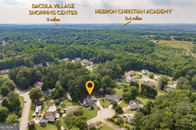 870 Rutherford Dr, Dacula, GA 30019 - aerial perspective of suburban area featuring a heavily wooded area