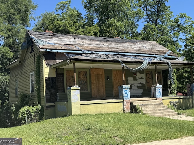1425 3rd St, Macon, GA 31201 - view of front of house featuring covered porch, a front yard, and a shingled roof