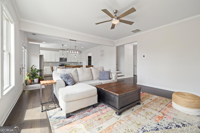 1998 Lakeview Bend Way, Buford, GA 30519 - living room with ceiling fan, dark wood-style flooring, baseboards, crown molding, and stairway
