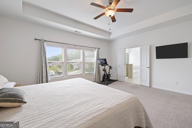 1998 Lakeview Bend Way, Buford, GA 30519 - carpeted bedroom featuring a tray ceiling, baseboards, ensuite bath, and a ceiling fan