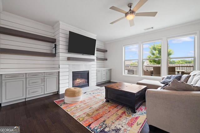 1998 Lakeview Bend Way, Buford, GA 30519 - living room with dark wood finished floors, ceiling fan, crown molding, and a fireplace with flush hearth