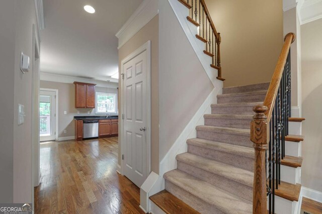 2264 Ewell Park Dr, Lawrenceville, GA 30043 - stairs featuring crown molding, wood finished floors, baseboards, and recessed lighting