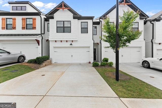 61 N Auburn Landing Pl, Auburn, GA 30011 - townhome / multi-family property featuring concrete driveway, a garage, and a standing seam roof