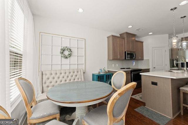 61 N Auburn Landing Pl, Auburn, GA 30011 - kitchen with black / electric stove, stainless steel microwave, a sink, light countertops, and healthy amount of natural light