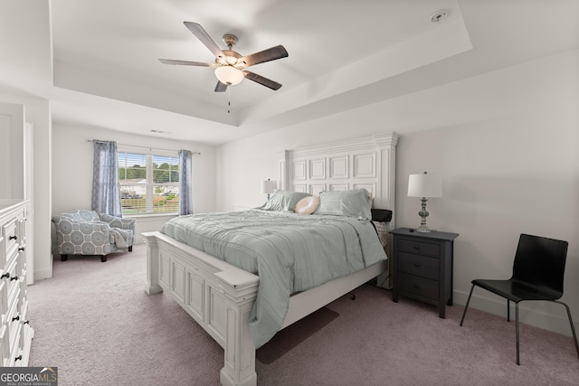 61 N Auburn Landing Pl, Auburn, GA 30011 - bedroom featuring a tray ceiling, light carpet, and a ceiling fan