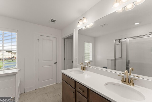 61 N Auburn Landing Pl, Auburn, GA 30011 - full bath featuring double vanity, plenty of natural light, tile patterned flooring, and an enclosed shower