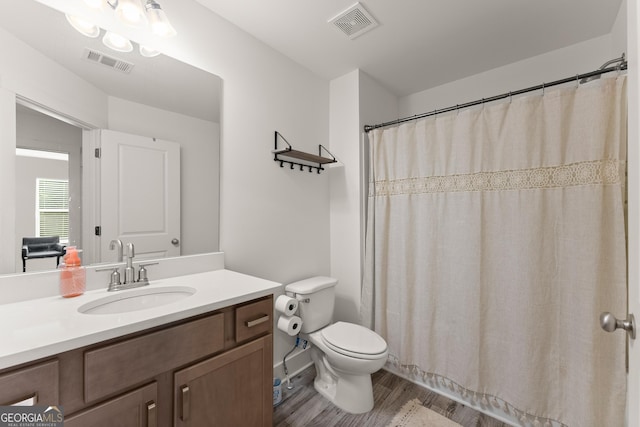 61 N Auburn Landing Pl, Auburn, GA 30011 - full bathroom with toilet, vanity, wood finished floors, and a shower with curtain