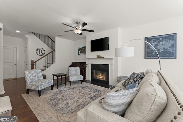 61 N Auburn Landing Pl, Auburn, GA 30011 - living area featuring wood finished floors, a ceiling fan, a glass covered fireplace, and stairs