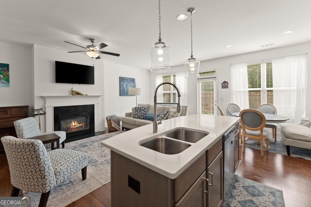 61 N Auburn Landing Pl, Auburn, GA 30011 - kitchen featuring a sink, open floor plan, a glass covered fireplace, a ceiling fan, and light countertops