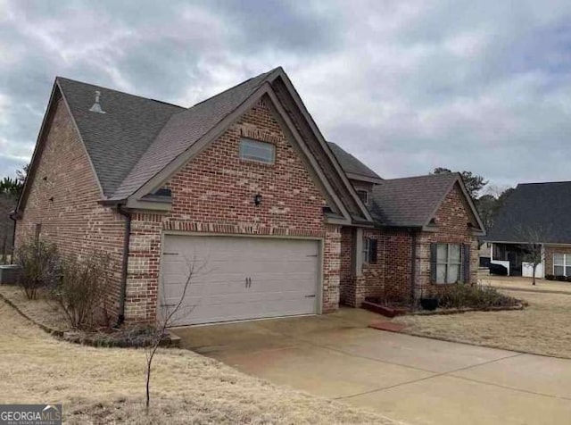 3349 Alhambra Cir, Hampton, GA 30228 - view of front of home with brick siding, concrete driveway, roof with shingles, and a garage