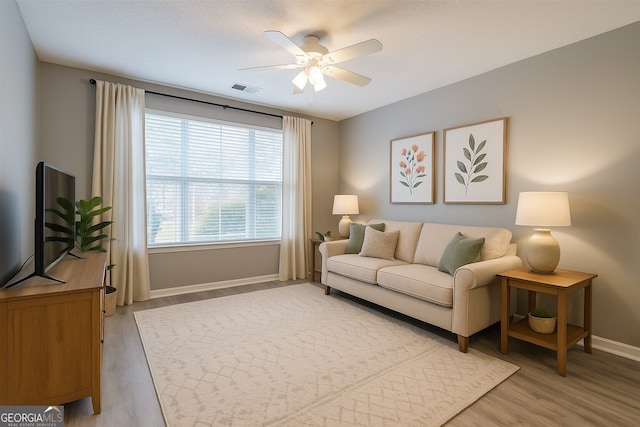 7432 Battlecreek Ln, Jonesboro, GA 30236 - living area featuring a ceiling fan and light wood-style floors